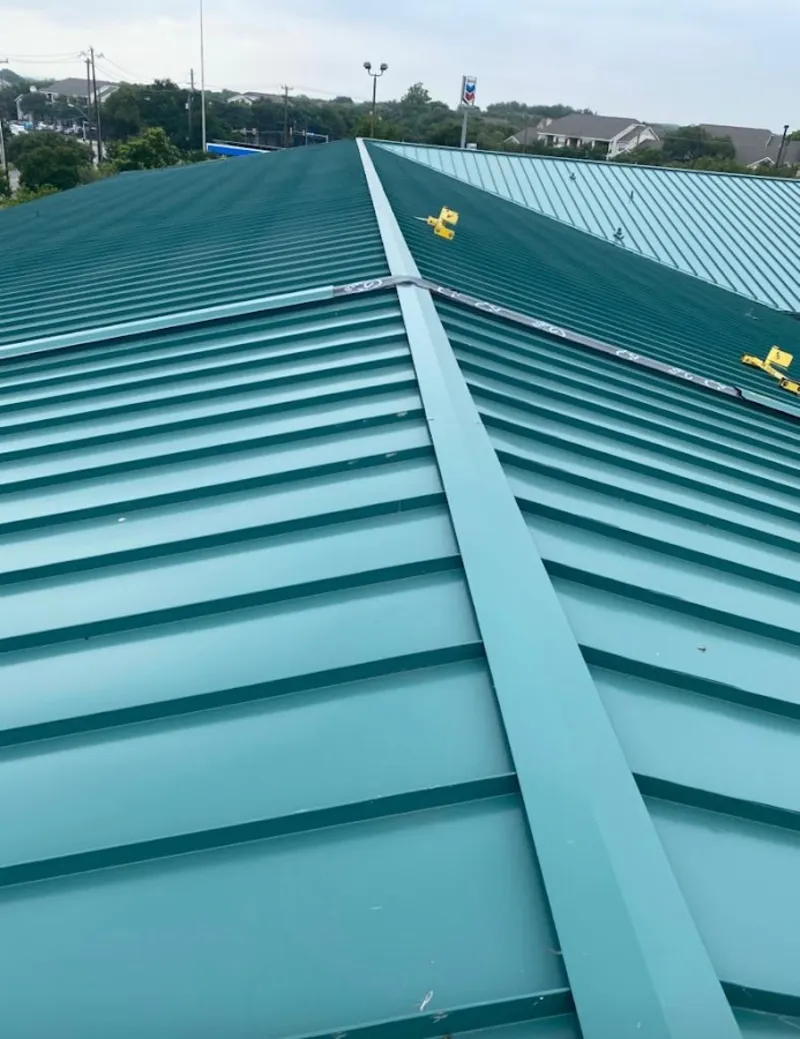 Green commercial metal roof ridge and valley for Metal Roof Repair in Paloma Creek South