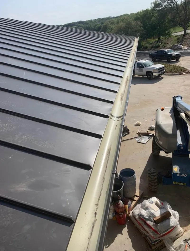 Standing seam panel and gutter detail on a metal roofing jobsite in Paloma Creek South